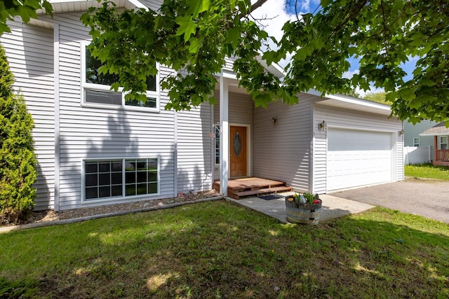 5 Darlene Rd, Columbia Falls, MT 59912 - view of front of house featuring a garage, a front lawn, and asphalt driveway