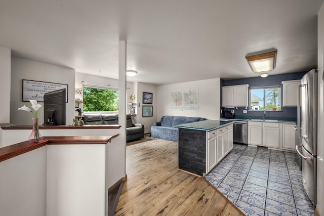 5 Darlene Rd, Columbia Falls, MT 59912 - kitchen with open floor plan, appliances with stainless steel finishes, white cabinetry, and light wood-style flooring