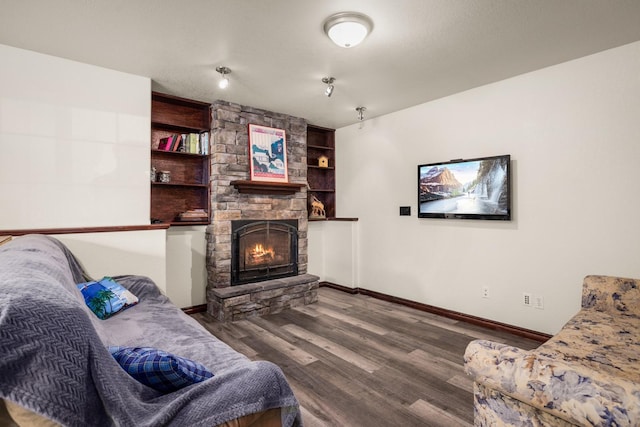 5 Darlene Rd, Columbia Falls, MT 59912 - living area featuring wood finished floors, a fireplace, baseboards, and built in shelves