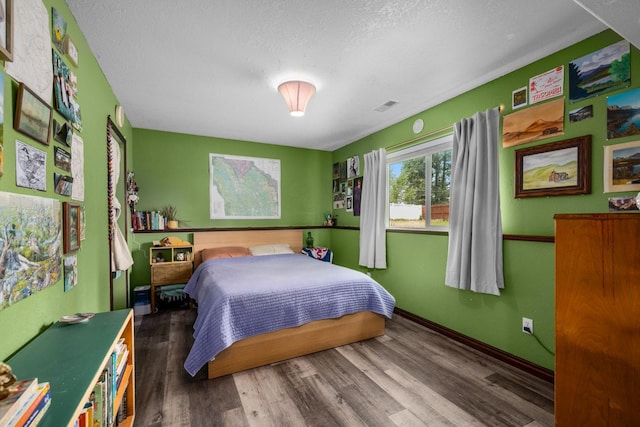 5 Darlene Rd, Columbia Falls, MT 59912 - bedroom featuring wood finished floors, a textured ceiling, and baseboards