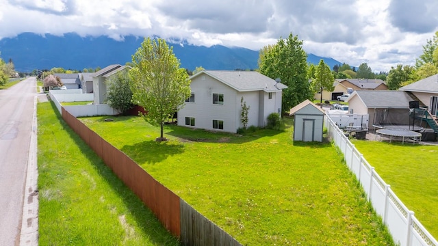 5 Darlene Rd, Columbia Falls, MT 59912 - rear view of house featuring a residential view, a mountain view, and a trampoline