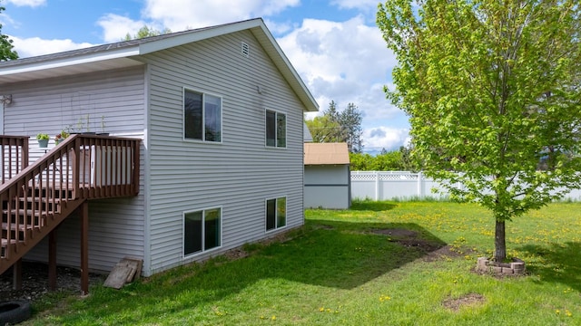 5 Darlene Rd, Columbia Falls, MT 59912 - back of property with a wooden deck and stairway