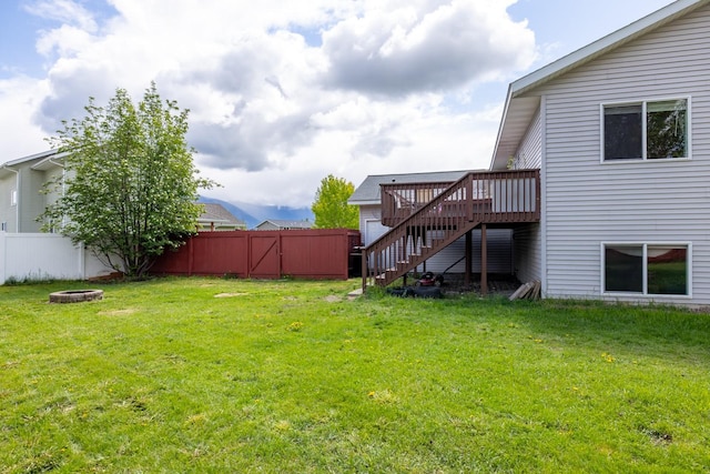 5 Darlene Rd, Columbia Falls, MT 59912 - view of yard featuring stairway, a wooden deck, and a fire pit