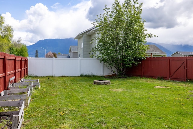 5 Darlene Rd, Columbia Falls, MT 59912 - view of yard with a fire pit, a mountain view, and a vegetable garden