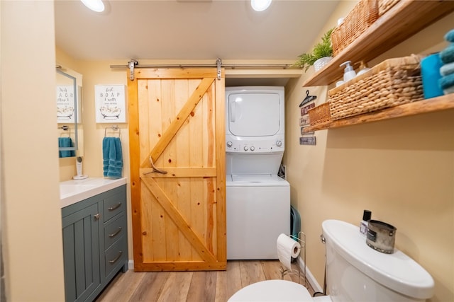 11537 Mt Highway 37 N, Libby, MT 59923 - bathroom with stacked washer / drying machine, toilet, wood finished floors, and vanity
