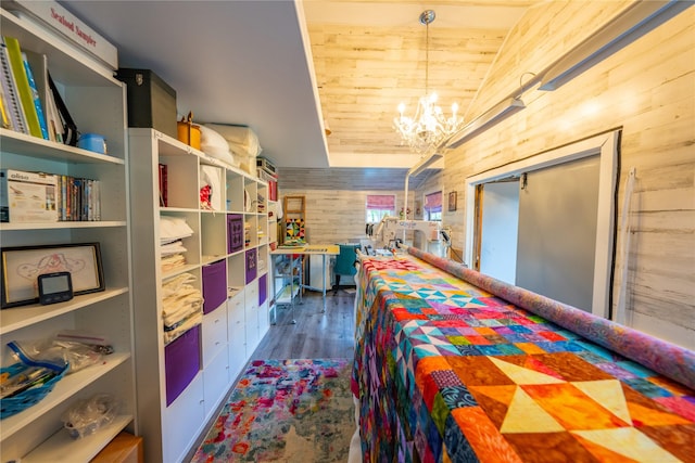 11537 Mt Highway 37 N, Libby, MT 59923 - bedroom featuring a chandelier, wood finished floors, vaulted ceiling, and wooden walls