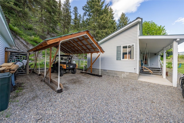 11537 Mt Highway 37 N, Libby, MT 59923 - view of parking featuring gravel driveway and a carport