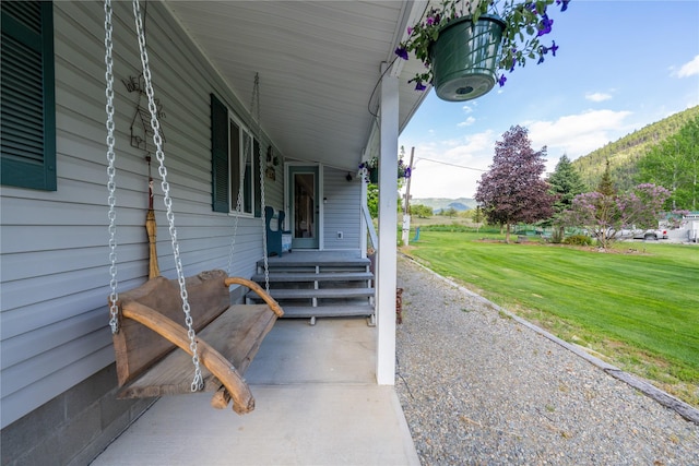 11537 Mt Highway 37 N, Libby, MT 59923 - porch featuring a mountain view and a lawn