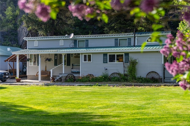 11537 Mt Highway 37 N, Libby, MT 59923 - view of front of home featuring a porch, a front yard, and metal roof