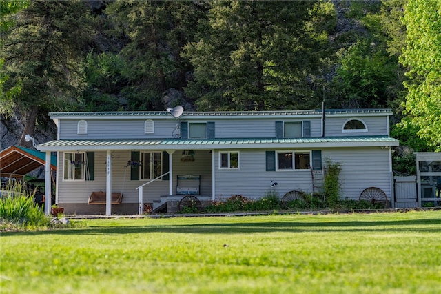 11537 Mt Highway 37 N, Libby, MT 59923 - view of front of home with covered porch, a front lawn, and metal roof