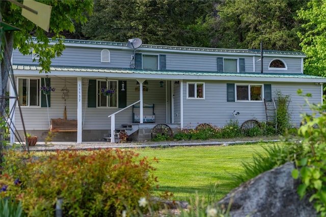 11537 Mt Highway 37 N, Libby, MT 59923 - view of front of property with a front yard, covered porch, and metal roof