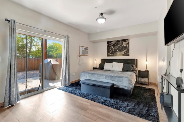 4100 Mullan Rd Unit 102, Missoula, MT 59808 - bedroom featuring access to outside, a wall mounted air conditioner, wood finished floors, and baseboards