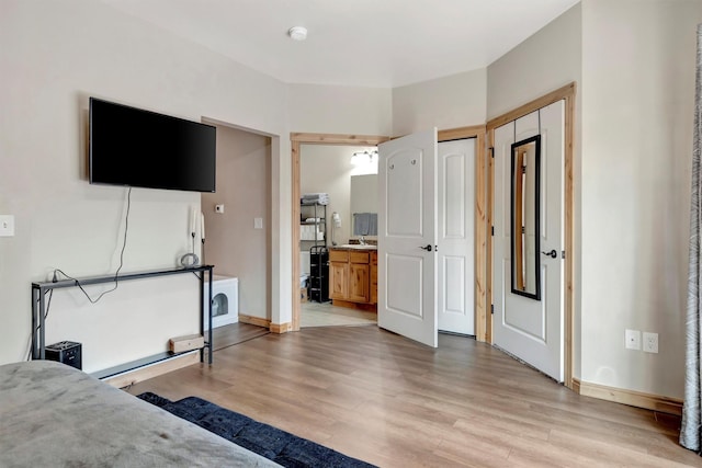 4100 Mullan Rd Unit 102, Missoula, MT 59808 - bedroom with light wood-style flooring, two closets, baseboards, and ensuite bathroom
