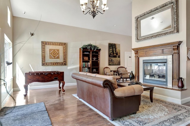 4100 Mullan Rd Unit 102, Missoula, MT 59808 - living room with a chandelier, baseboards, wood finished floors, high vaulted ceiling, and a premium fireplace