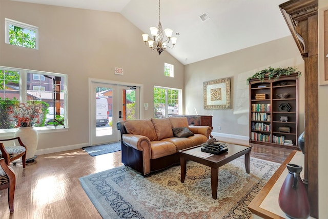 4100 Mullan Rd Unit 102, Missoula, MT 59808 - living area with a chandelier, baseboards, high vaulted ceiling, wood finished floors, and french doors