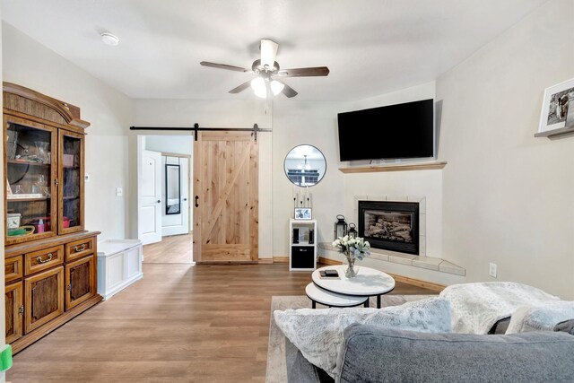4100 Mullan Rd Unit 102, Missoula, MT 59808 - living area with ceiling fan, wood finished floors, a barn door, and a tile fireplace
