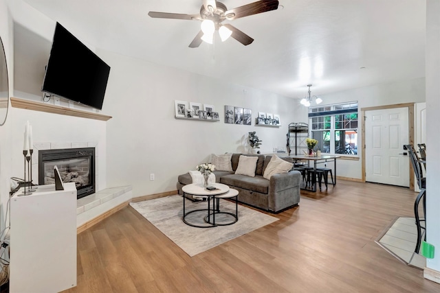 4100 Mullan Rd Unit 102, Missoula, MT 59808 - living room featuring wood finished floors, a fireplace, a ceiling fan, and baseboards