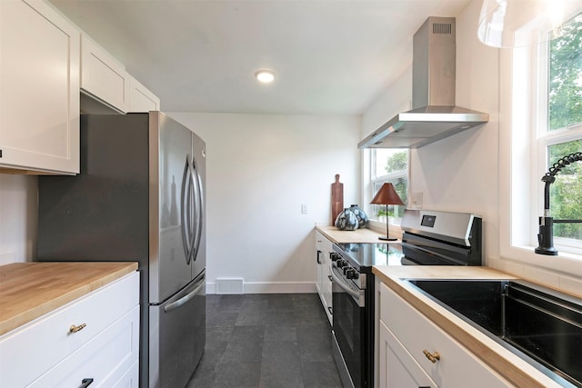 2929 Sunrise Promenade Promenade, Missoula, MT 59801 - kitchen with stainless steel appliances, wall chimney exhaust hood, a sink, white cabinetry, and recessed lighting