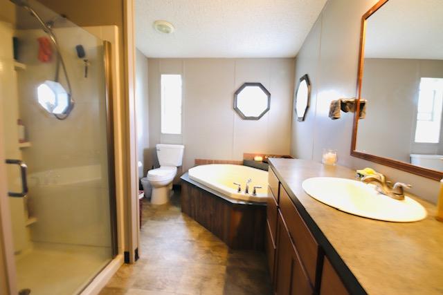 4757 Richlie, Missoula, MT 59808 - full bath featuring plenty of natural light, a stall shower, vanity, and a bath