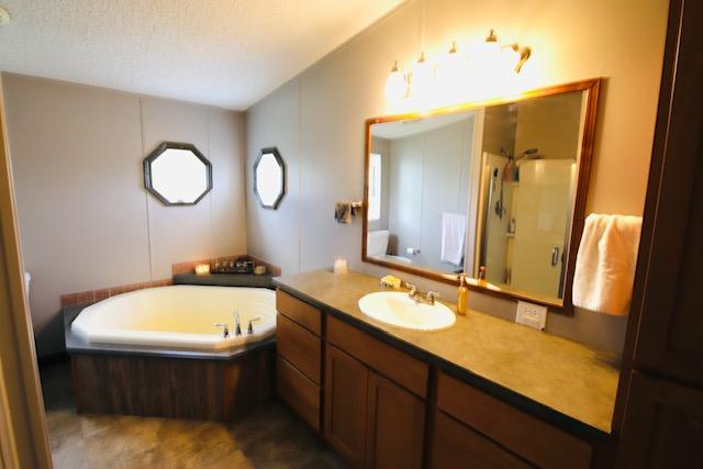 4757 Richlie, Missoula, MT 59808 - full bath with vanity, a bath, and a stall shower