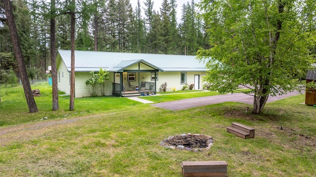 13033 Trinkus Ln, Bigfork, MT 59911 - ranch-style home with metal roof and a front lawn
