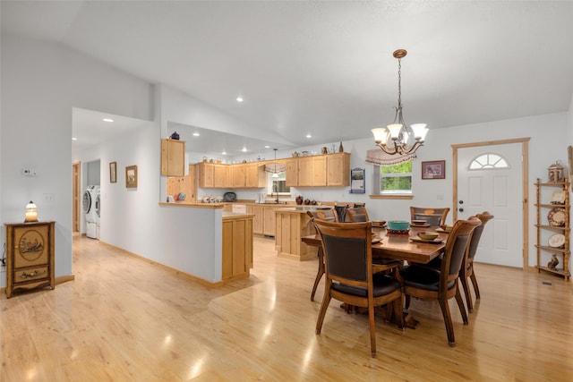 13033 Trinkus Ln, Bigfork, MT 59911 - dining space with vaulted ceiling, washer and clothes dryer, a chandelier, light wood-style floors, and recessed lighting