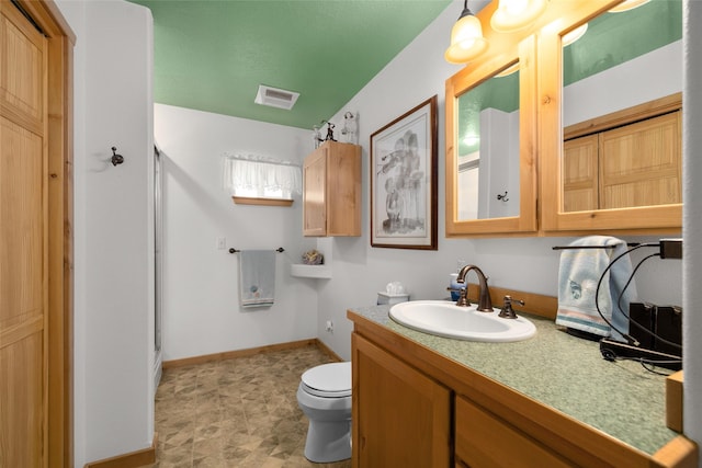 13033 Trinkus Ln, Bigfork, MT 59911 - full bath with vanity, toilet, baseboards, and a shower stall