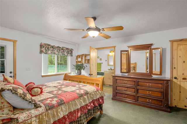 13033 Trinkus Ln, Bigfork, MT 59911 - bedroom featuring carpet floors, connected bathroom, a textured ceiling, and a ceiling fan
