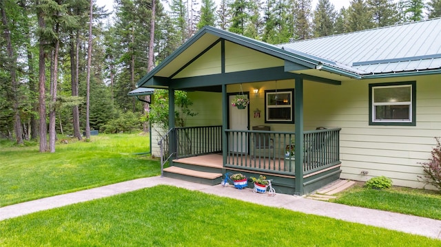 13033 Trinkus Ln, Bigfork, MT 59911 - bungalow-style house with covered porch, a front lawn, and metal roof