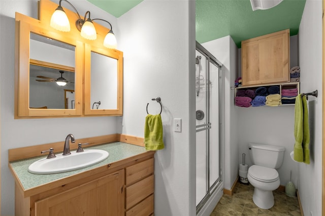 13033 Trinkus Ln, Bigfork, MT 59911 - bathroom with toilet, vanity, a shower stall, and baseboards