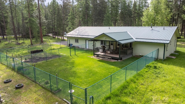 13033 Trinkus Ln, Bigfork, MT 59911 - rear view of property featuring a wooden deck, metal roof, a gate, and a forest view