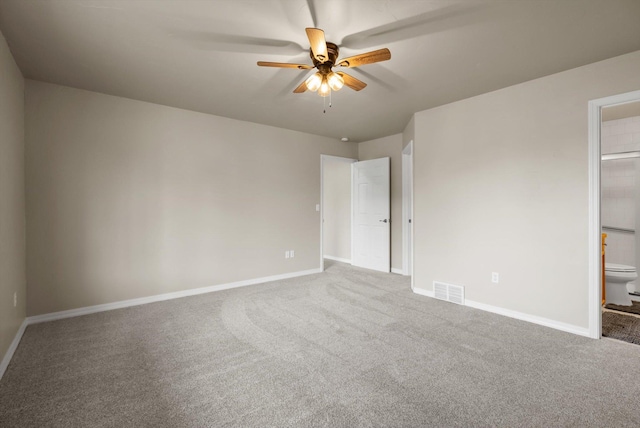 28 Bethany St, Columbia Falls, MT 59912 - unfurnished bedroom featuring carpet floors, baseboards, connected bathroom, and a ceiling fan