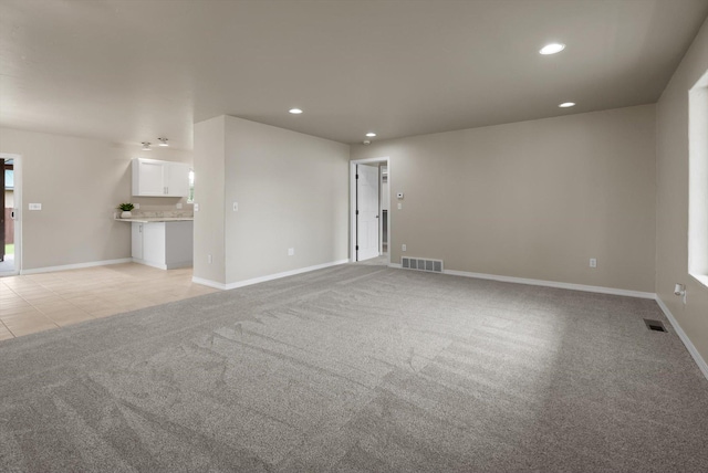 28 Bethany St, Columbia Falls, MT 59912 - unfurnished living room featuring recessed lighting, light colored carpet, baseboards, and light tile patterned floors