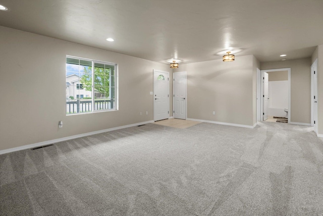 28 Bethany St, Columbia Falls, MT 59912 - unfurnished living room with light carpet, baseboards, and recessed lighting