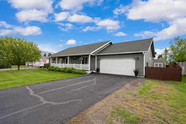 28 Bethany St, Columbia Falls, MT 59912 - ranch-style house with covered porch, a garage, asphalt driveway, and roof with shingles