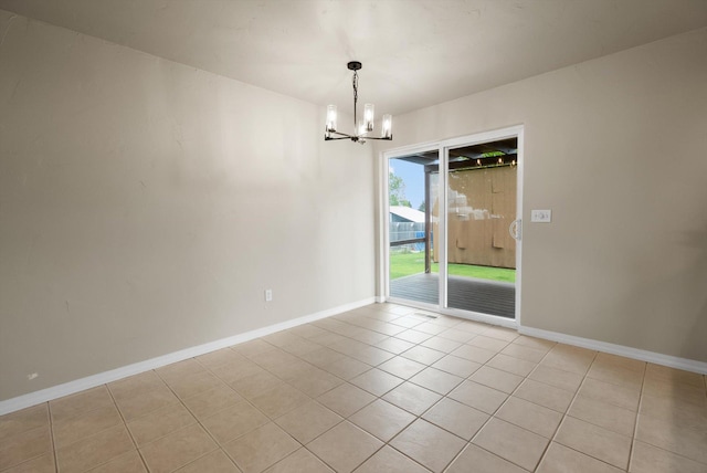 28 Bethany St, Columbia Falls, MT 59912 - unfurnished room with a chandelier, light tile patterned flooring, and baseboards