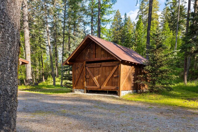131 Mccaffery Lookout Trl, Bigfork, MT 59911 - view of outbuilding with a forest view