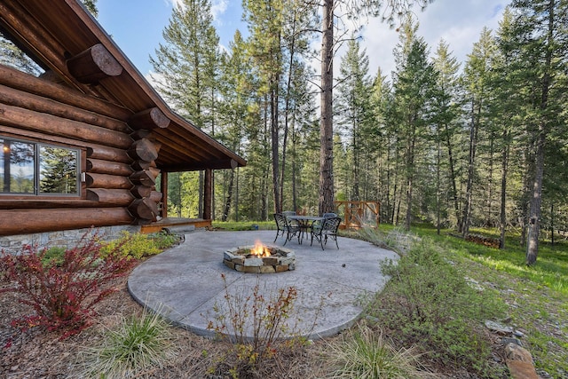 131 Mccaffery Lookout Trl, Bigfork, MT 59911 - view of yard featuring an outdoor fire pit and a patio