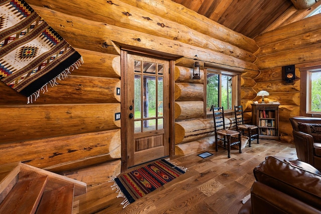 131 Mccaffery Lookout Trl, Bigfork, MT 59911 - foyer with vaulted ceiling, wood-type flooring, wood ceiling, plenty of natural light, and rustic walls