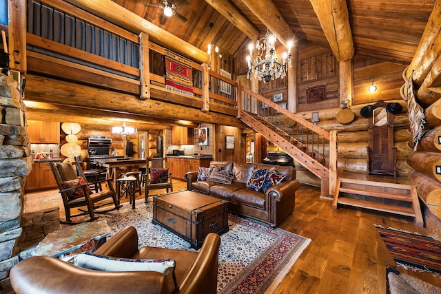 131 Mccaffery Lookout Trl, Bigfork, MT 59911 - living area with wooden ceiling with exposed beams, dark wood-style floors, stairway, rustic walls, and high vaulted ceiling