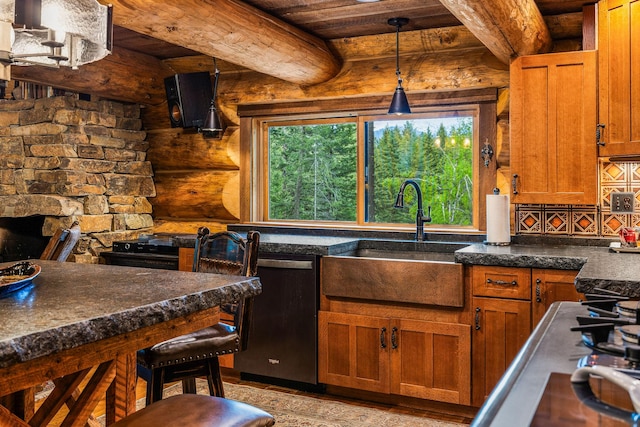 131 Mccaffery Lookout Trl, Bigfork, MT 59911 - kitchen featuring a sink, dishwasher, brown cabinetry, pendant lighting, and rustic walls