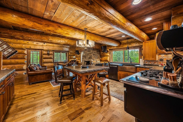 131 Mccaffery Lookout Trl, Bigfork, MT 59911 - kitchen with dishwashing machine, dark countertops, wood ceiling with exposed beams, light wood finished floors, and recessed lighting