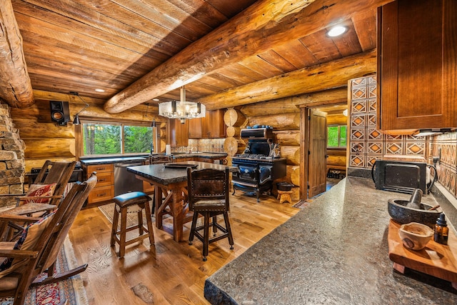 131 Mccaffery Lookout Trl, Bigfork, MT 59911 - dining space featuring wooden ceiling with exposed beams, rustic walls, light wood-style flooring, a chandelier, and recessed lighting