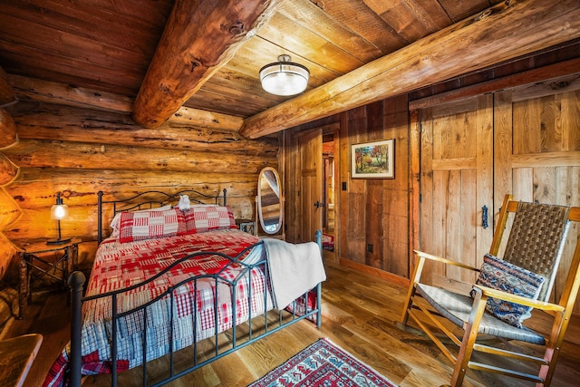 131 Mccaffery Lookout Trl, Bigfork, MT 59911 - bedroom with wooden ceiling with exposed beams and hardwood / wood-style floors