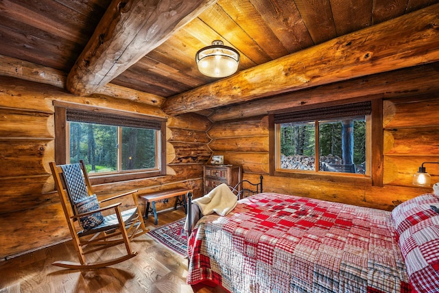 131 Mccaffery Lookout Trl, Bigfork, MT 59911 - bedroom with wooden ceiling with exposed beams, rustic walls, multiple windows, and hardwood / wood-style flooring