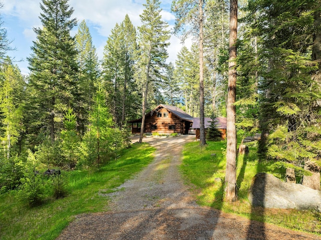 131 Mccaffery Lookout Trl, Bigfork, MT 59911 - log cabin with driveway and a forest view