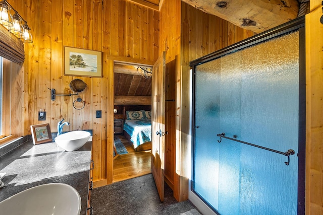 131 Mccaffery Lookout Trl, Bigfork, MT 59911 - ensuite bathroom with wood walls, a stall shower, and double vanity