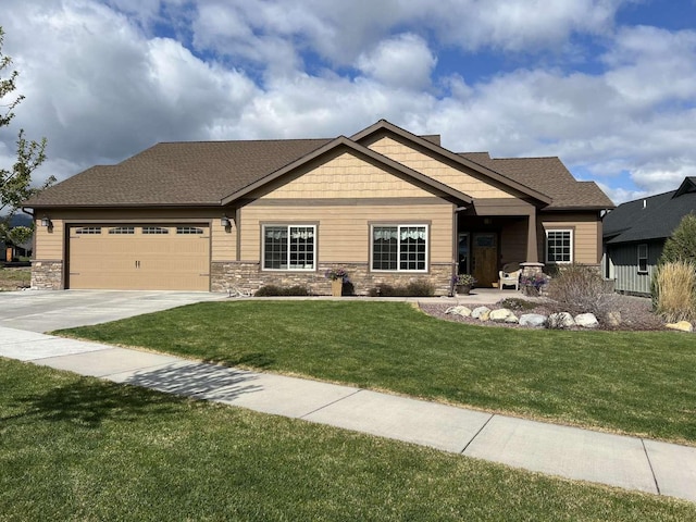 2669 Bunkhouse Pl, Missoula, MT 59808 - craftsman inspired home with concrete driveway, a garage, a front lawn, and stone siding