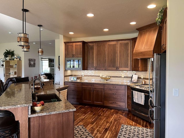 2669 Bunkhouse Pl, Missoula, MT 59808 - kitchen with a sink, black appliances, dark wood finished floors, a kitchen breakfast bar, and backsplash