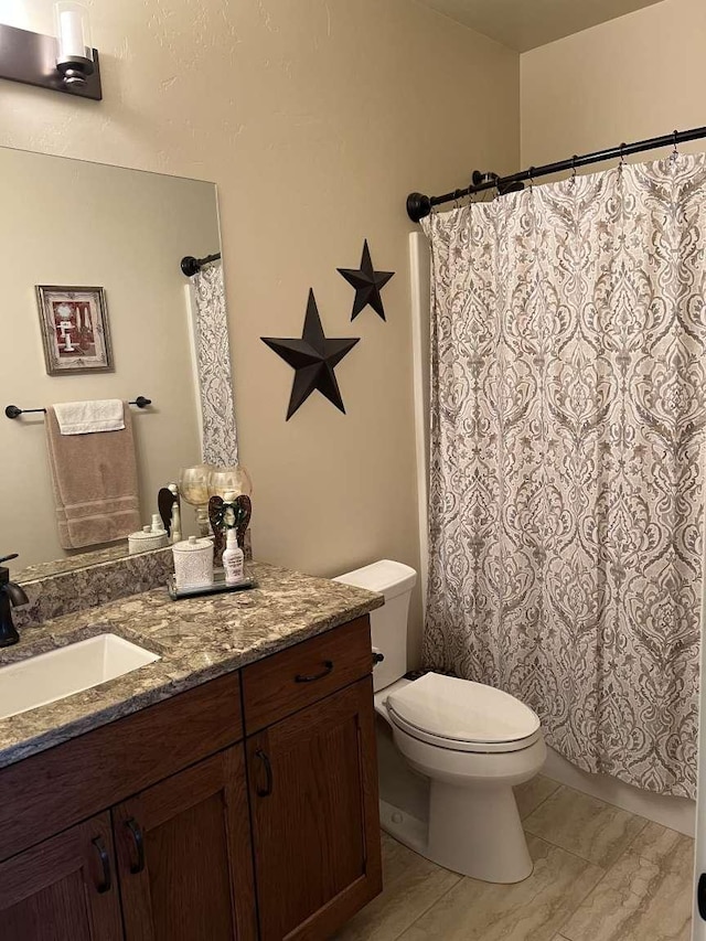 2669 Bunkhouse Pl, Missoula, MT 59808 - full bathroom featuring vanity, toilet, a shower with curtain, and marble finish flooring